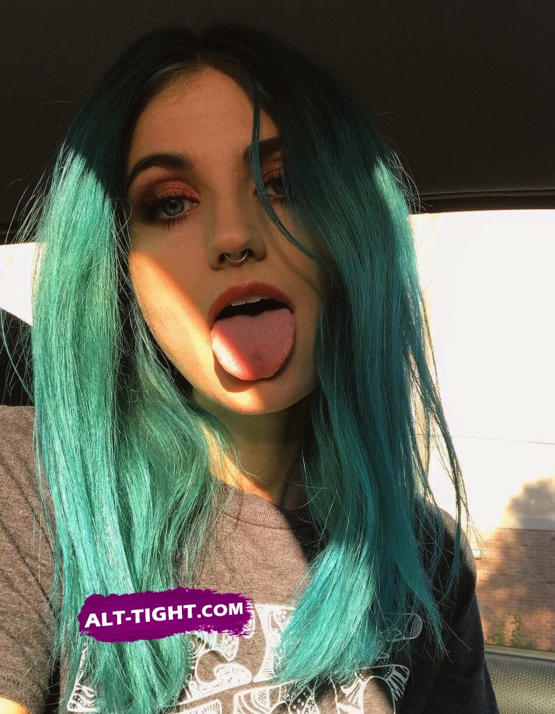 Punk liberal girl with green hair makes selfie with her mouth open and tongue out Punk liberal girl makes a blowjob tease selfie