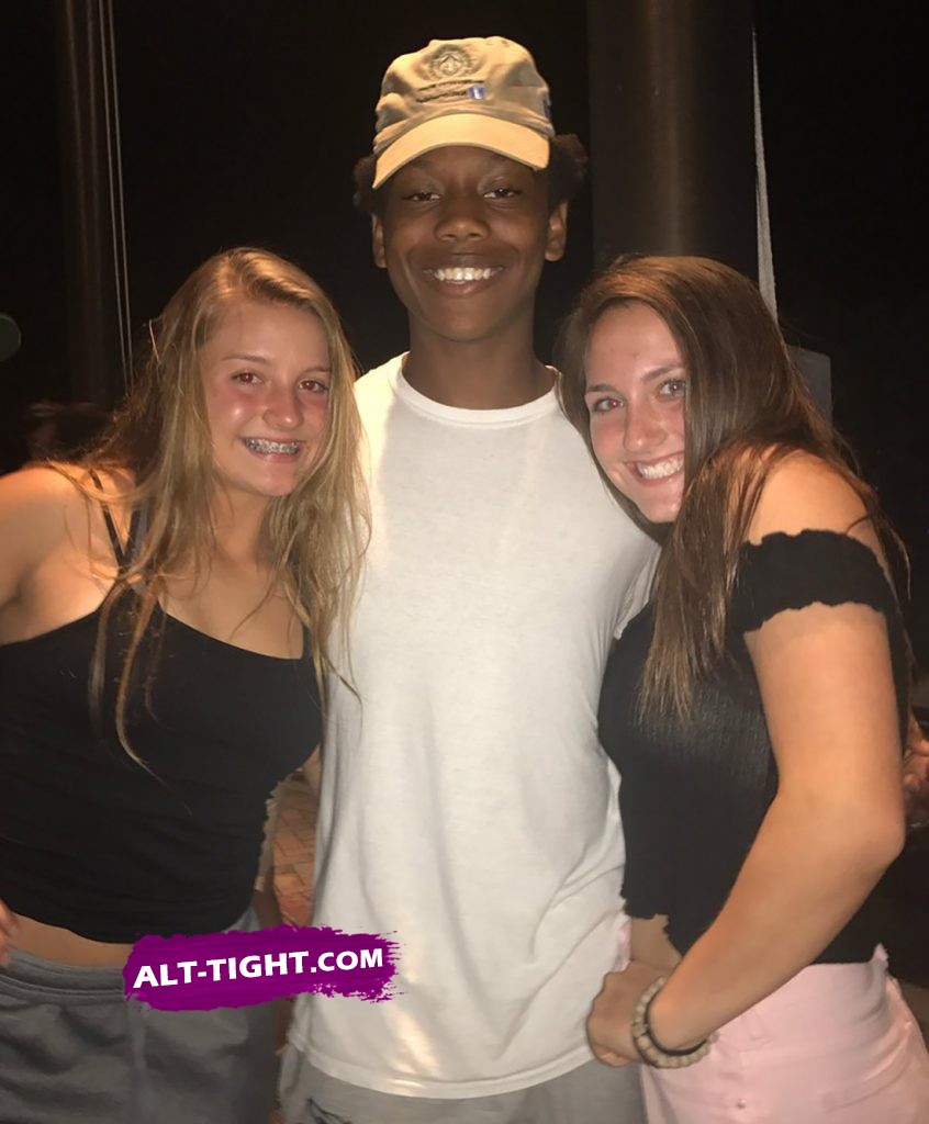 Hot white teen girls posing with a black boy in the middle Two hot white teens posing while hugging with a black boy