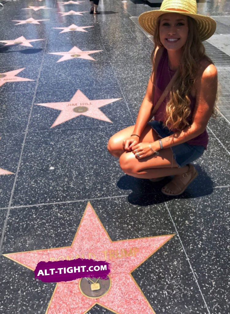 Happy smiling girl poses next to Trump's star after she cleaned it