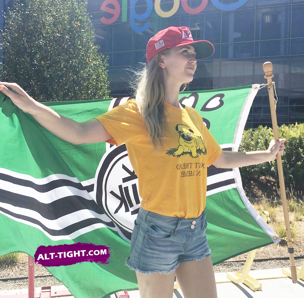 Pretty girl stands proudly in front of a right wing meme flag Gorgeous right wing girl poses in front of a meme flag