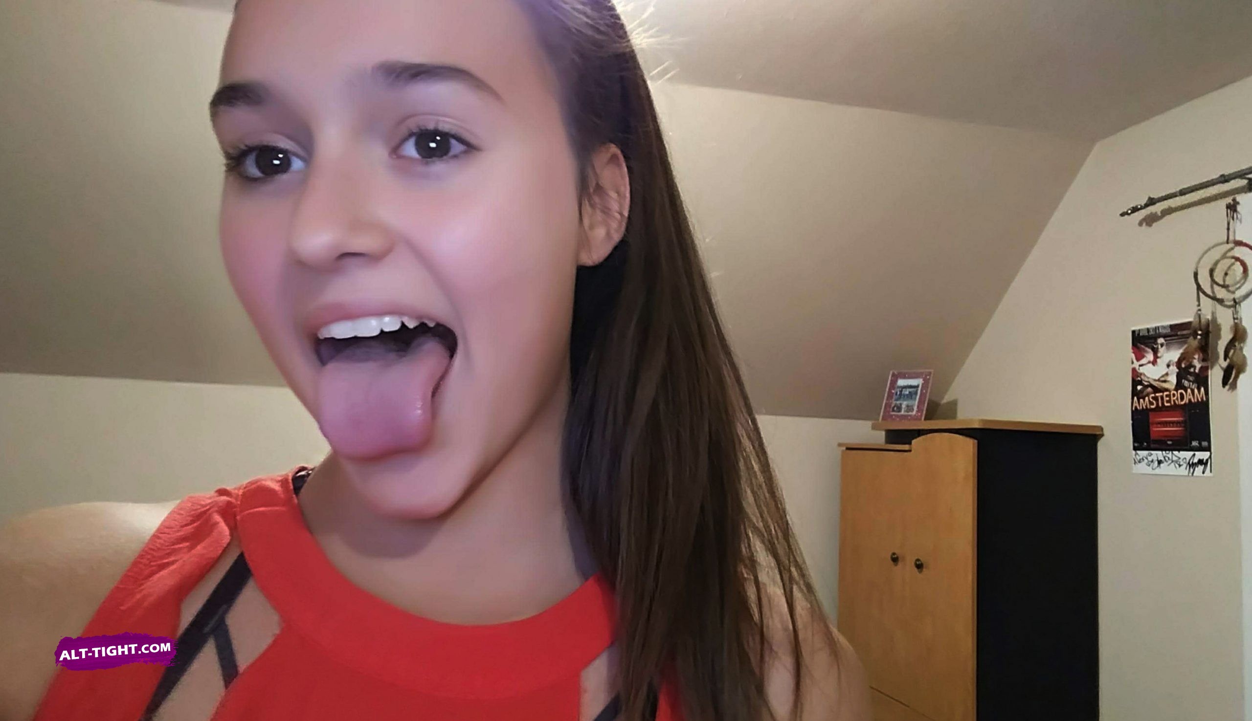 Young liberal girl shows off her long tongue to tease about oral sex Beautiful liberal girl shows off her long tongue
