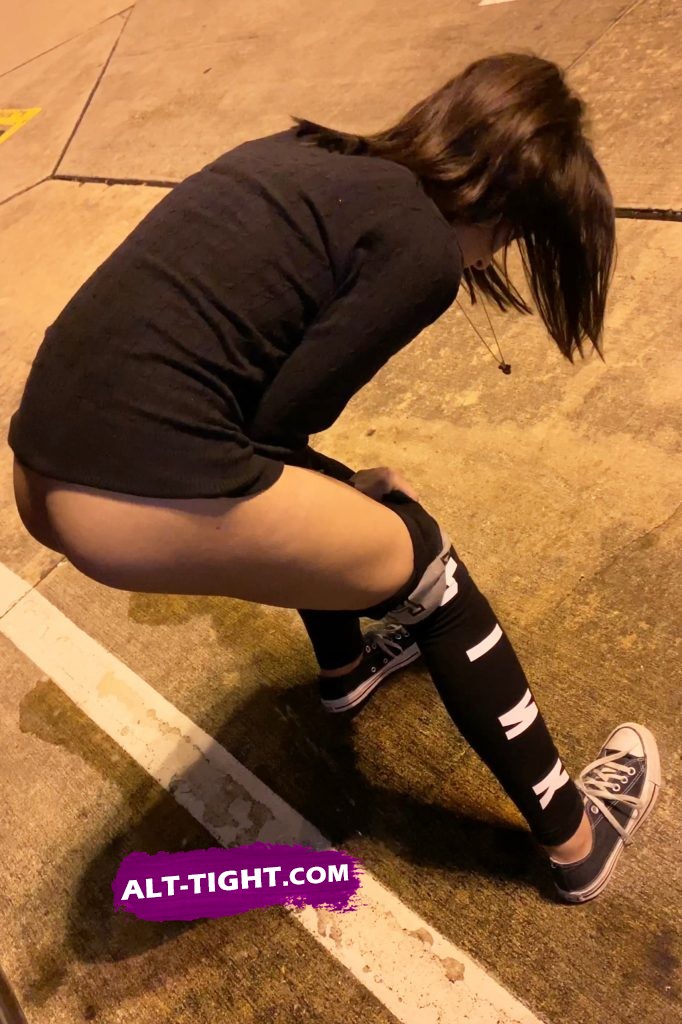 Punk girl drops pants and pisses on the street right in front of her friend Cute girl exposed naked ass while peeing on street